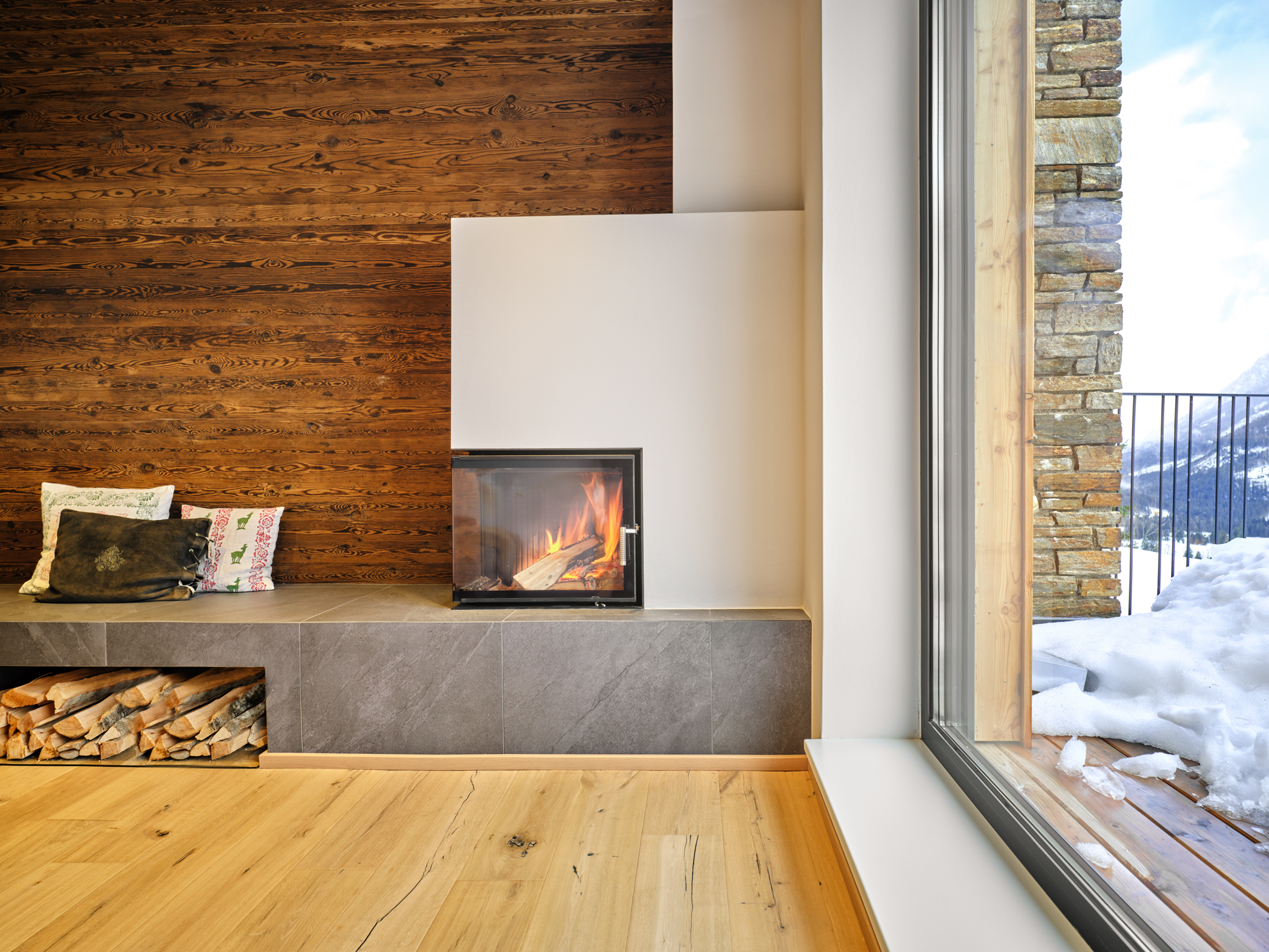 A fire laid in the corner, the valley white beyond the glass