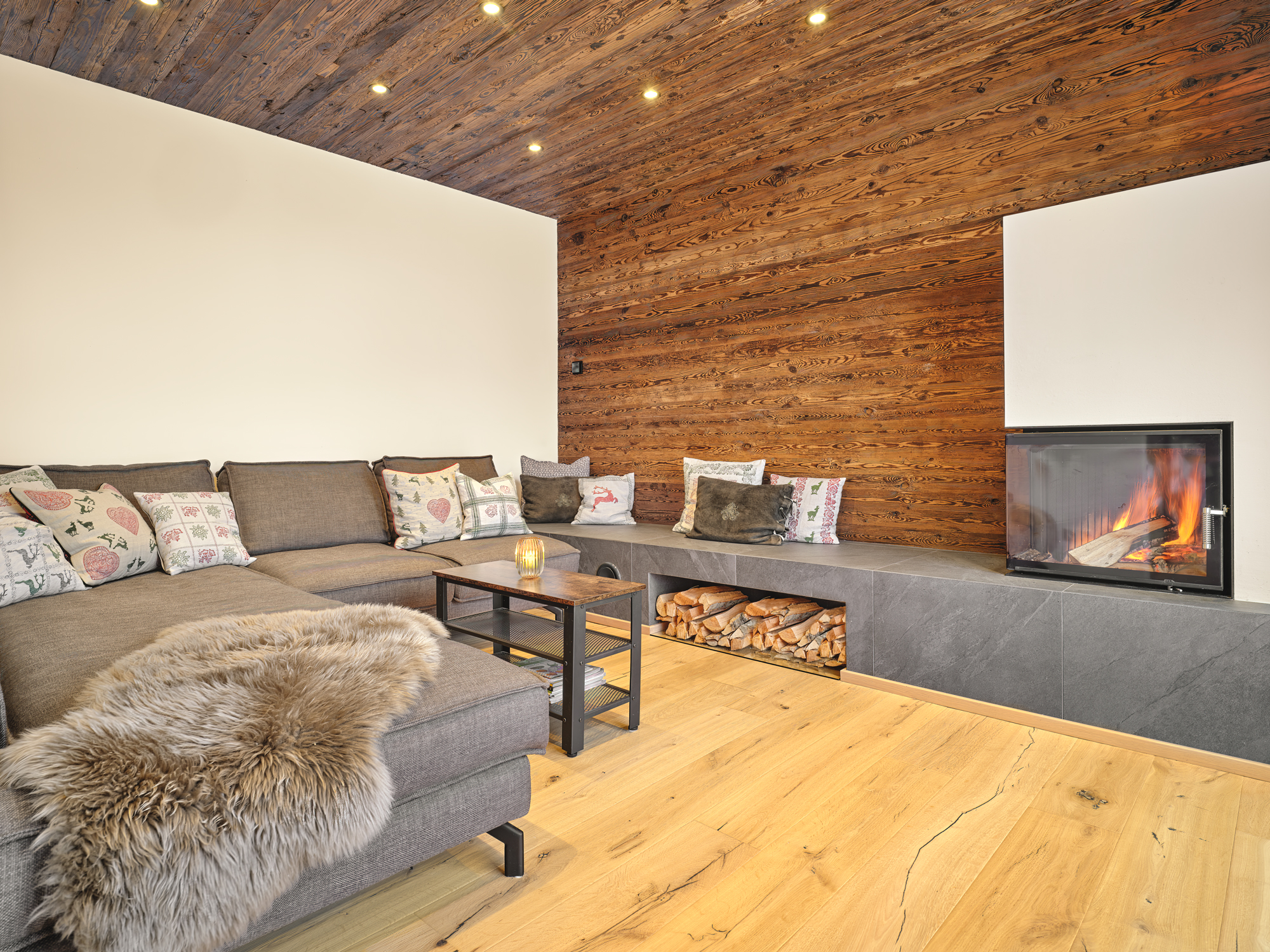 The lounge, a corner fire, sheepskin on the sofa